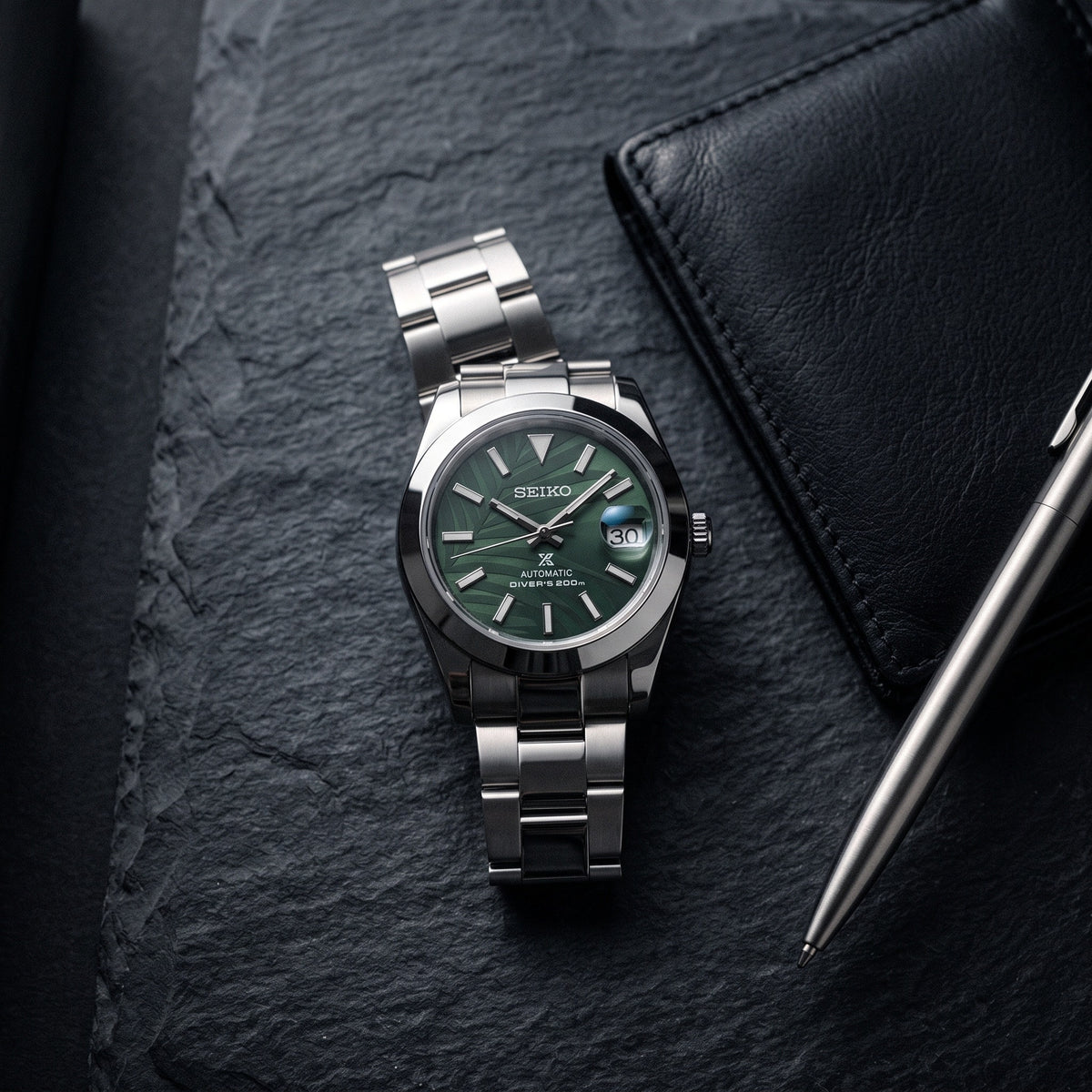 Date Mod – Steel · Green Stick Dial · Smooth Bezel – Automatic – lifestyle flat lay