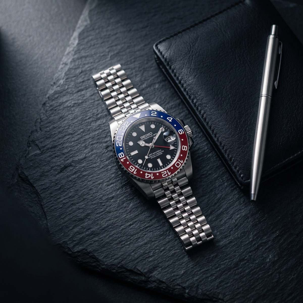 GMT Mod – Steel · Blue-Red Bezel · Jubilee – 40mm – Automatic GMT – lifestyle flat lay
