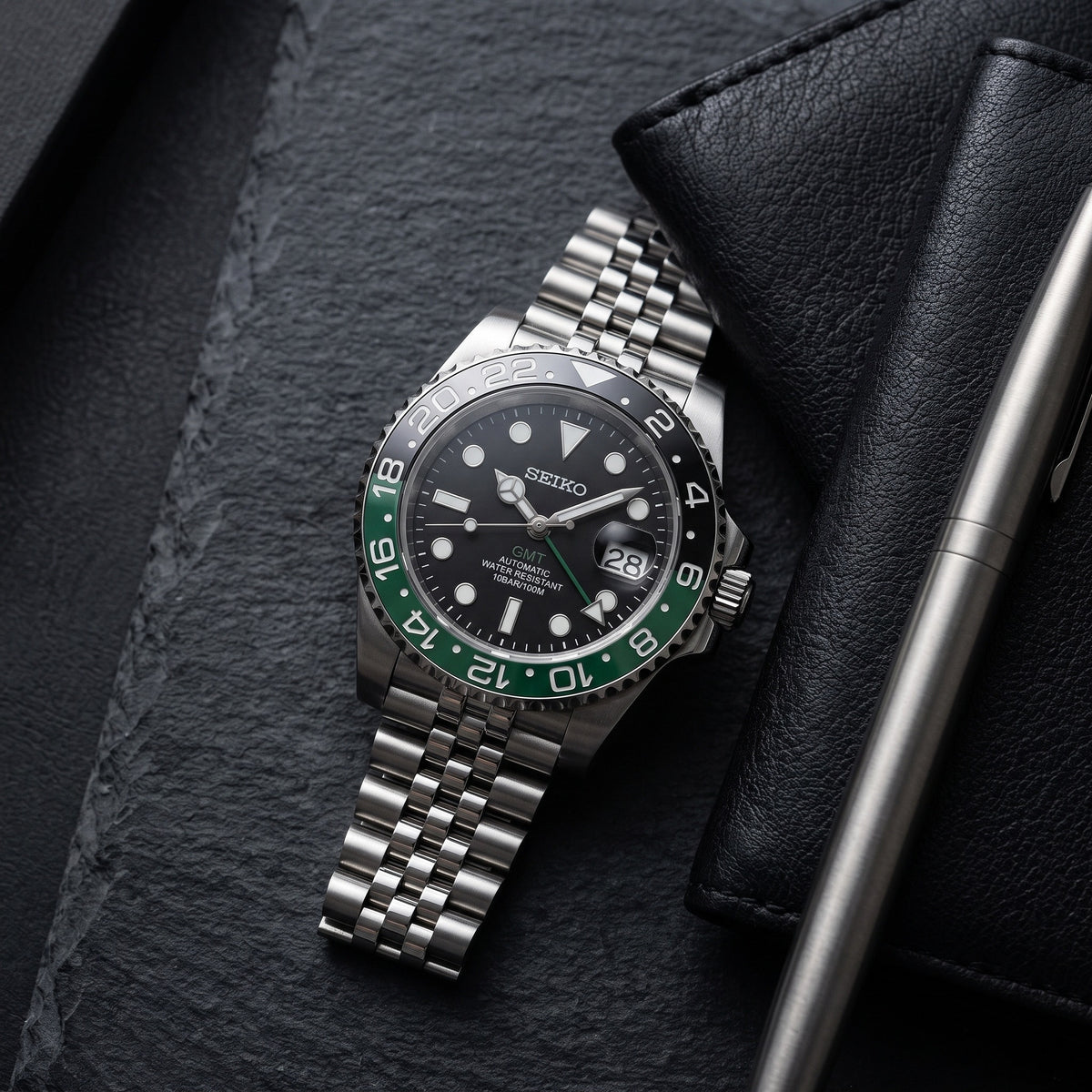GMT Mod – Steel · Green-Black Bezel – 40mm – Automatic GMT – lifestyle flat lay