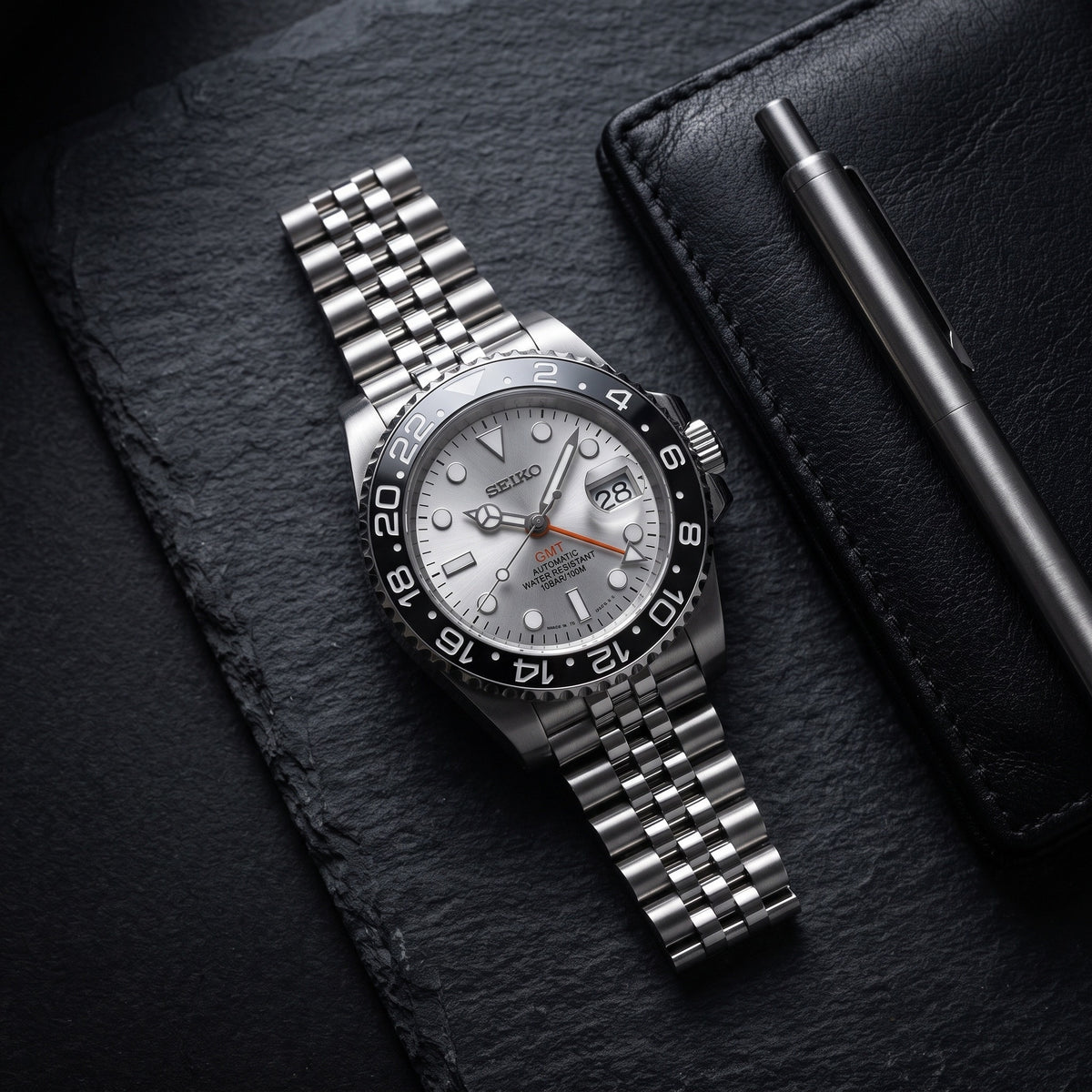 GMT Mod – Steel · Grey Bezel · Silver Dial – 40mm – Automatic GMT – lifestyle flat lay