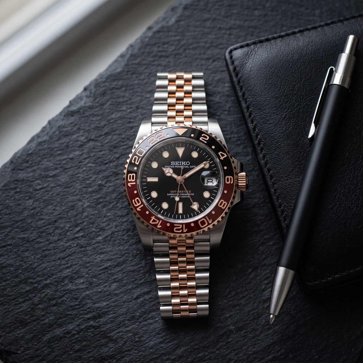GMT Mod – Two-Tone Rose Gold · Red-Black Bezel – 40mm – Automatic GMT – lifestyle flat lay