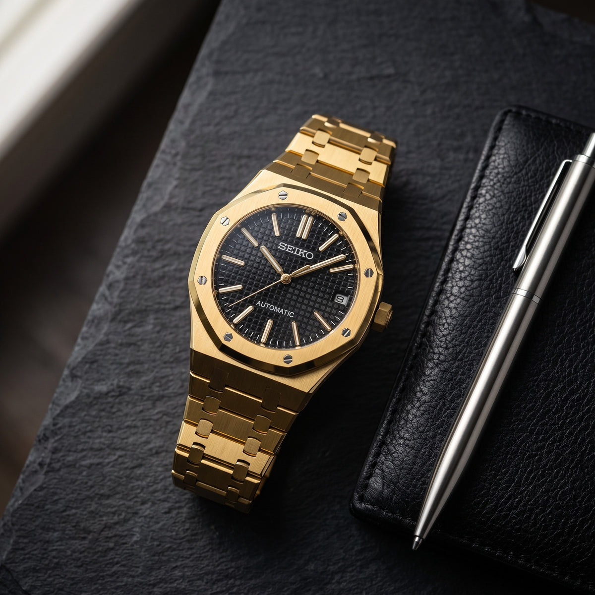 Oak Mod – Gold · Black Tapisserie Dial – 41mm – Automatic – lifestyle flat lay